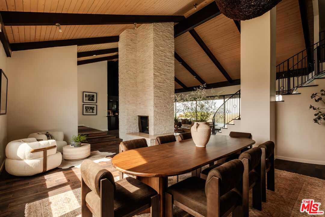 Dining room beside the stone fireplace with olive branch arrangement