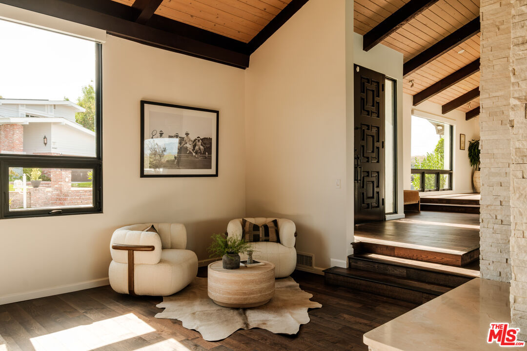 Entry sitting nook with boucle chairs beside the front door
