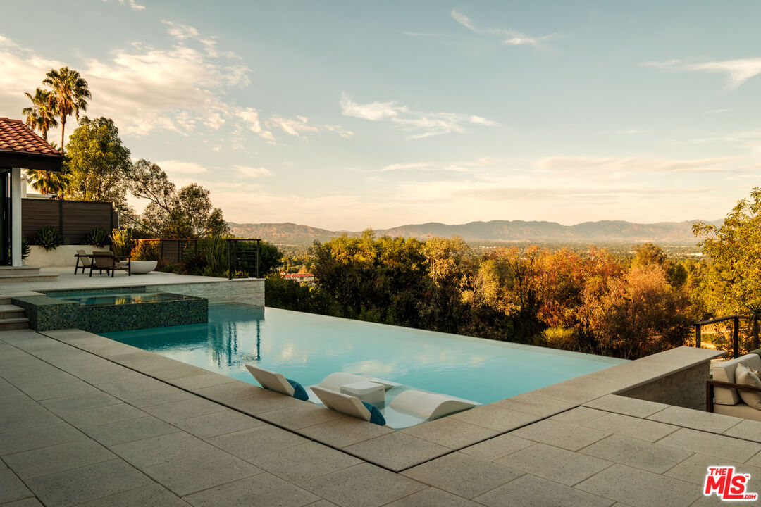 Infinity-edge pool at golden hour overlooking the San Fernando Valley