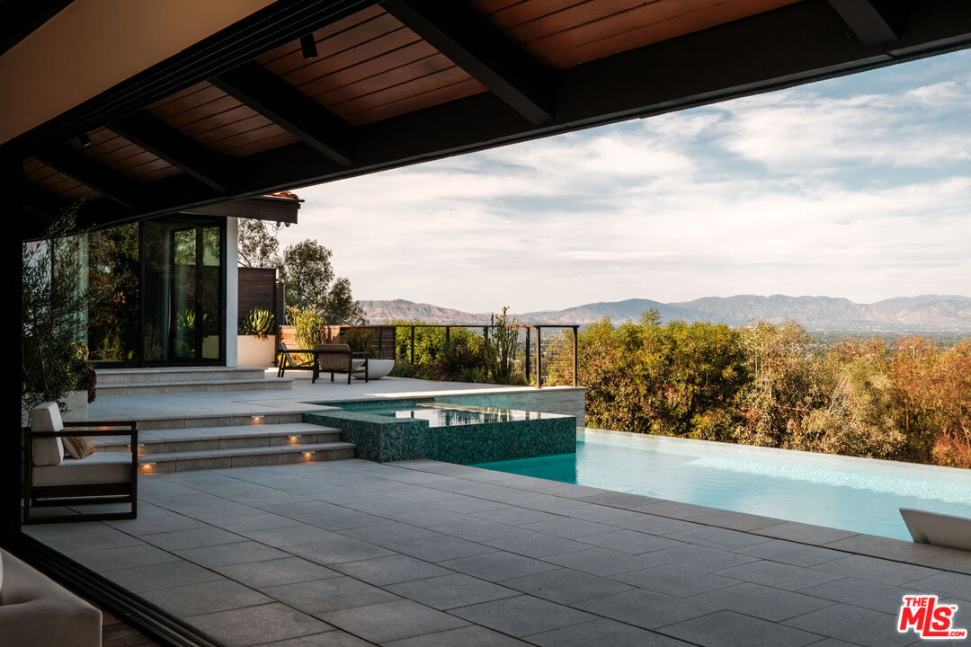 Infinity pool edge with the San Fernando Valley and mountains beyond