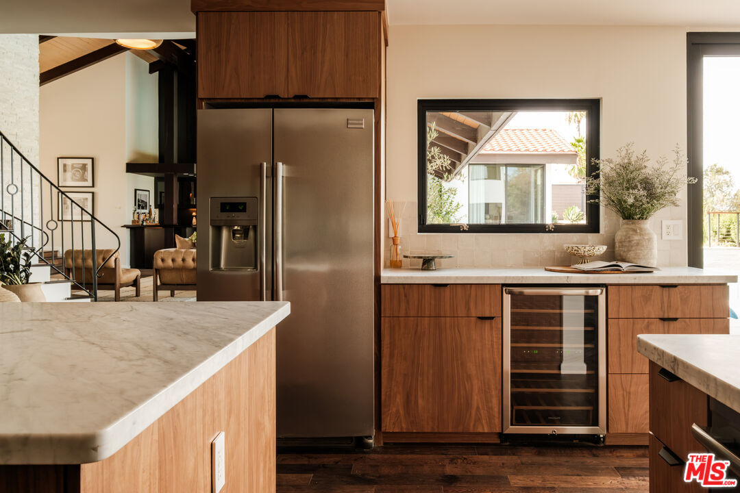 Paneled refrigerator and built-in wine fridge nook