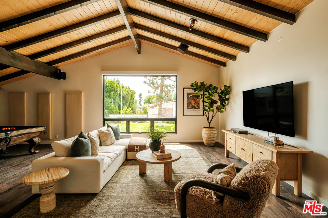 Media room lounge with sectional sofa and mounted television