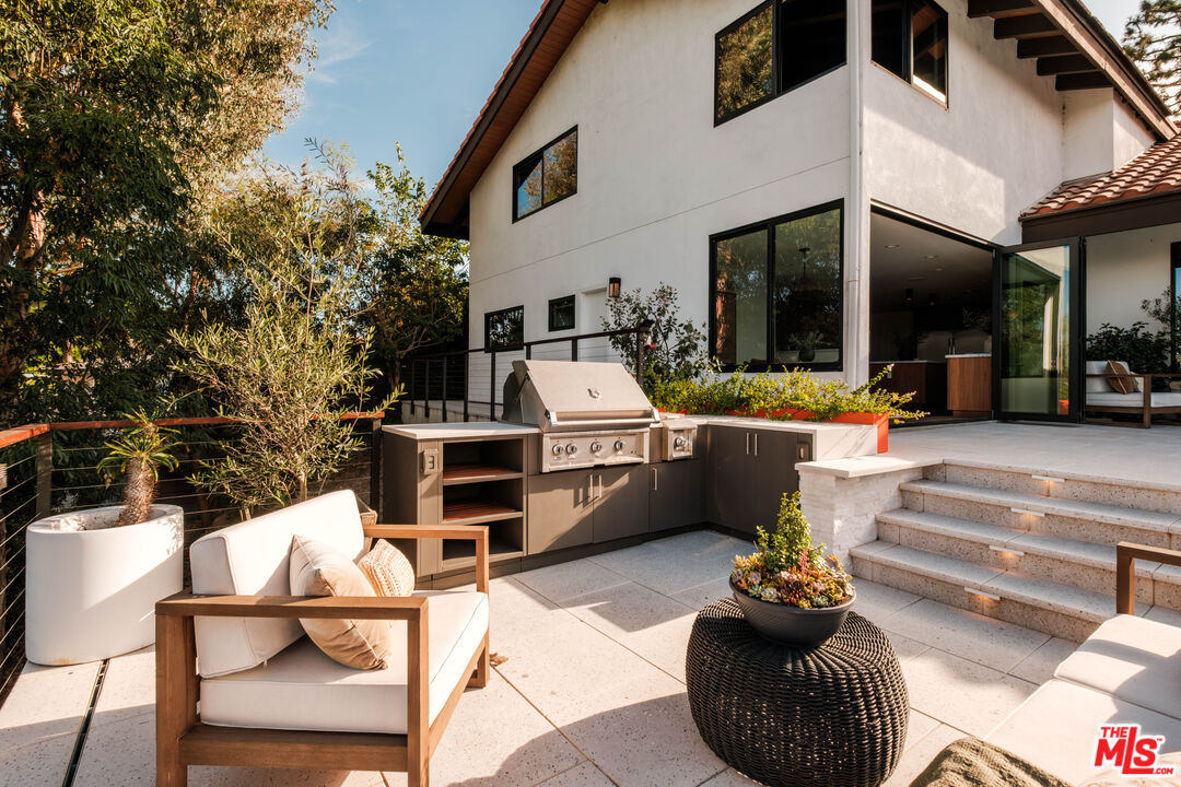 Outdoor kitchen with a built-in Hestan grill and Urban Bonfire cabinetry