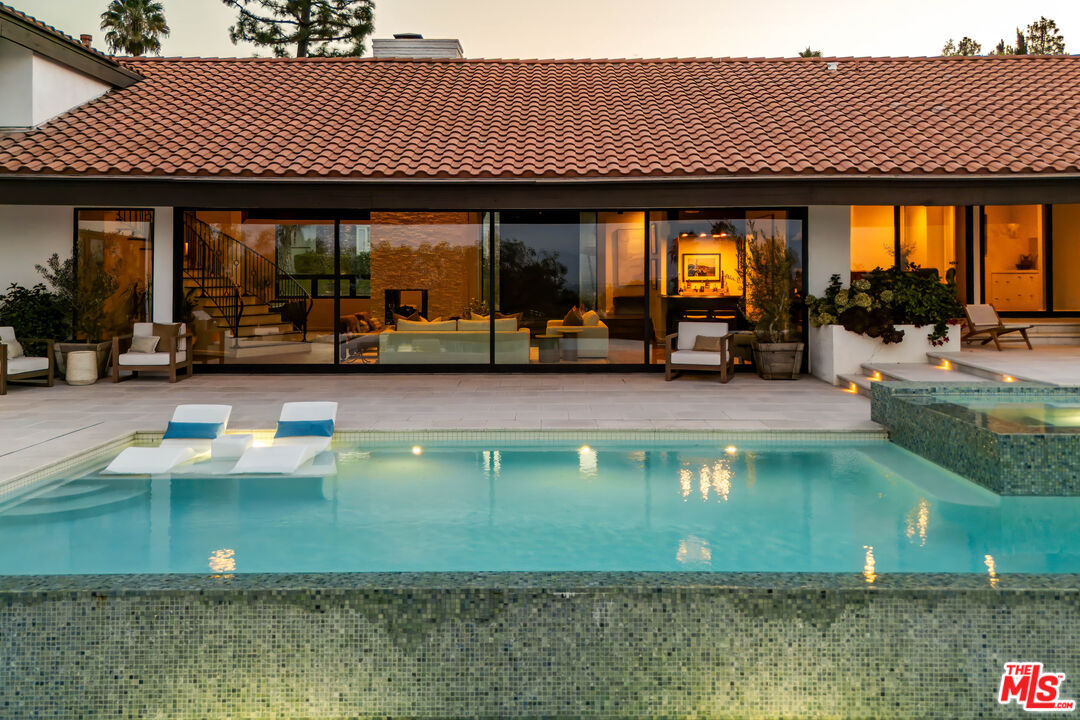 Twilight view of the saltwater pool and spa from the great room