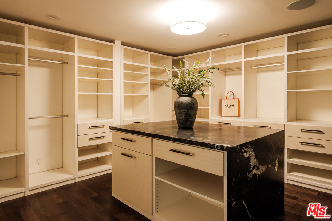 Custom island walk-in closet with marble-topped island